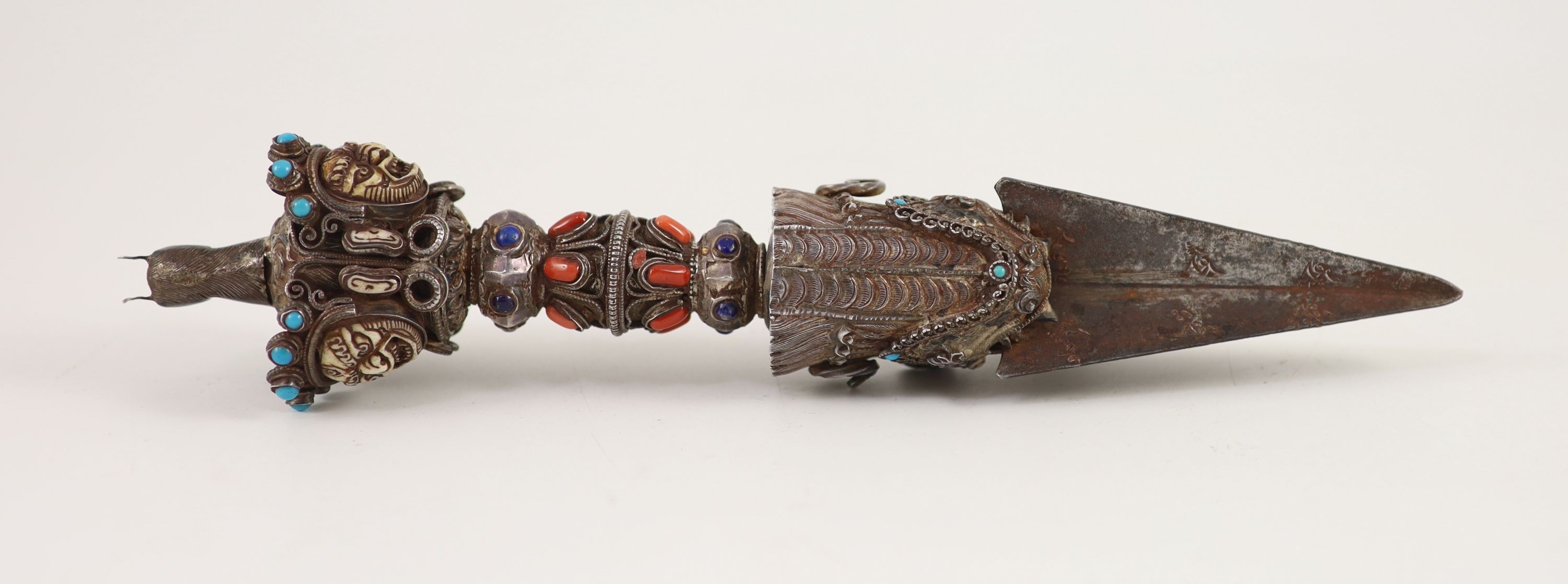 A Tibetan silver, bone and gem set phurbu (ritual dagger), 19th/20th century, 27.5 cm long, some of the stones replaced with glass